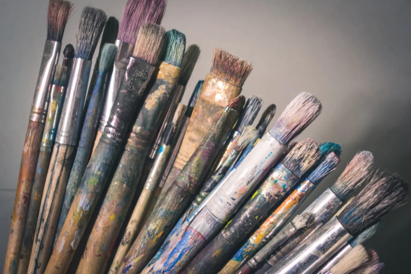 A rack of well used artist's brushes of different sizes, each shaped by the job it does